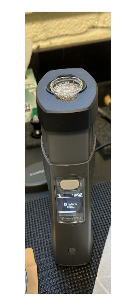 Near-infrared device scanning a sample.