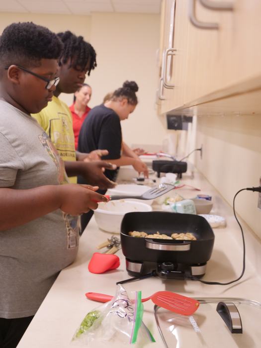 children learning to cook food