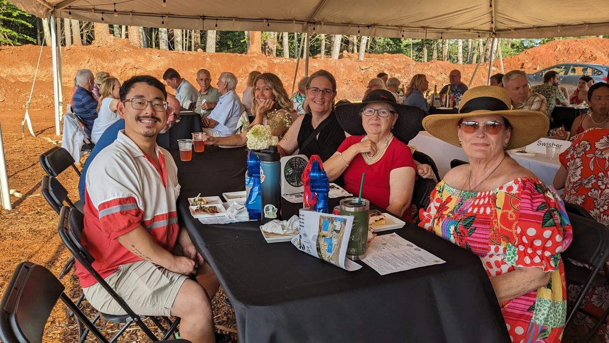 People sitting at table under a tent
