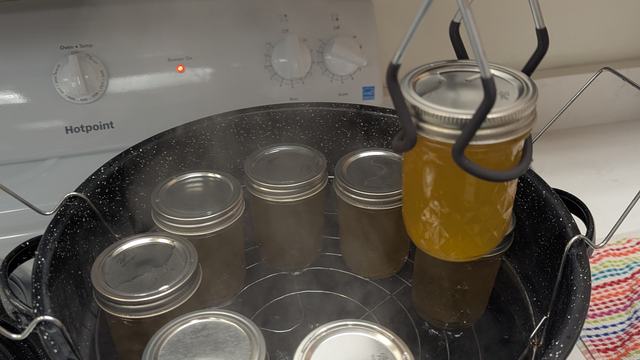 Family and Consumer Sciences Agent preserving food in demonstration kitchen.