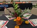table with fall flowers with NC Cooperative Extension logo behind it