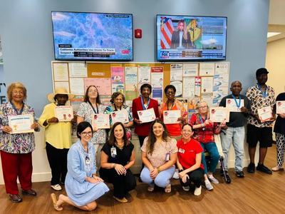 presenters and participants of Pressure Wise blood pressure education program posing holding certificates during graduation program at senior services