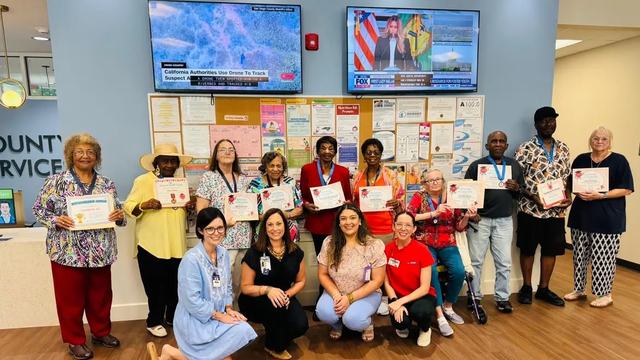 presenters and participants of Pressure Wise blood pressure education program posing holding certificates during graduation program at senior services