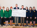 State 4-H Officers and State FFA Officers accept a Farm Credit check for $90,000 to NC 4‑H and FFA raised from Pull for Youth events across the state.