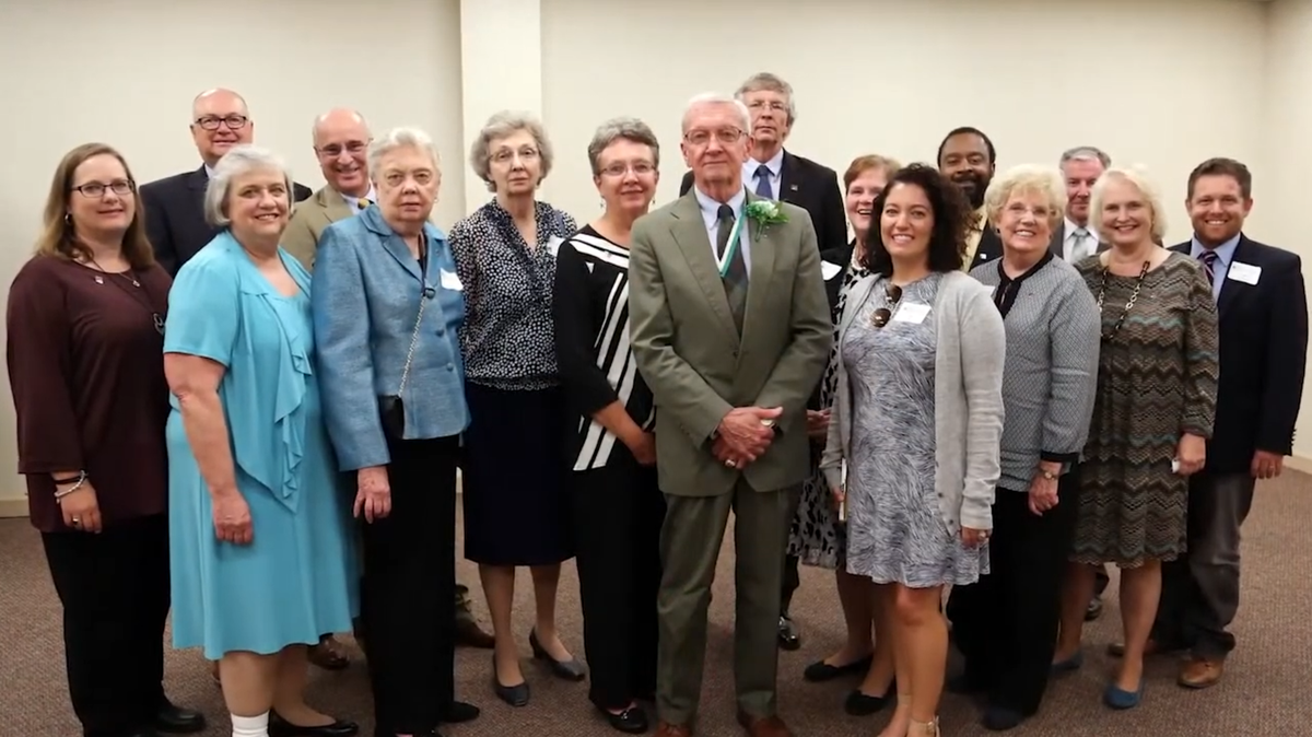 Jim Clark stands with a group of colleagues following his induction into the National 4-H Hall of Fame.