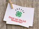 Clothes pin holding a notecard that says 'check out the 4-H newsletters.'