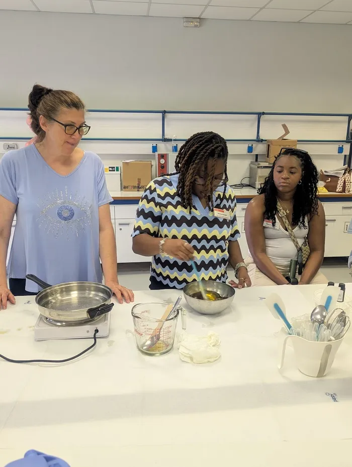 NC State doctoral student Shonna Smith (Agricultural Education and HumanSciences) creates balms and salves using beeswax, calendula oil, olive oil, andmore natural products as part of the natural skincare class.