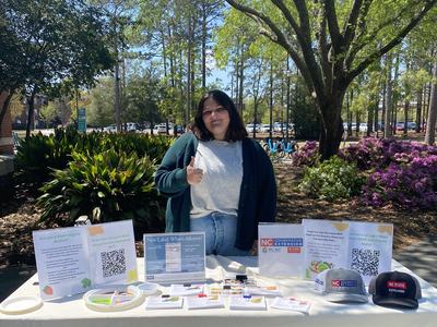 New FCS Agent Allison Mattocks at a tabling event at UNCW.