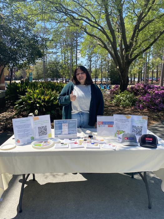 New FCS Agent Allison Mattocks at a tabling event at UNCW.