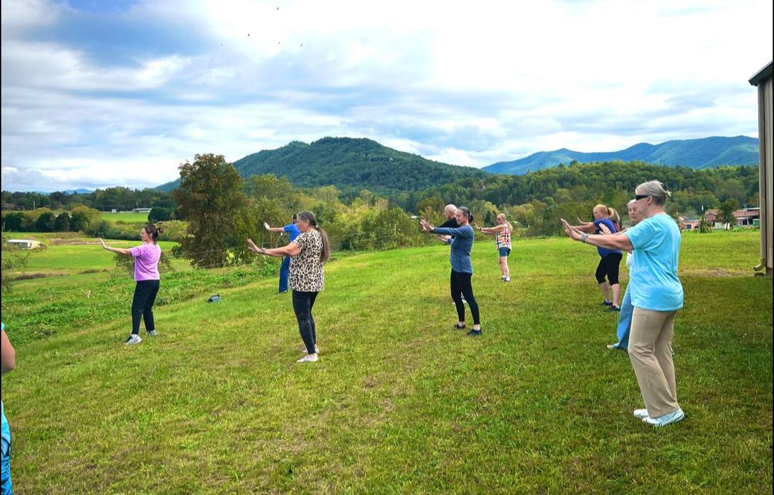 Group Tai Chi outside.