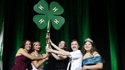 Members of the South Central District officer team pose with the State 4-H Vice President after receiving the Spirit Stick during the 2026 4-H Congress.