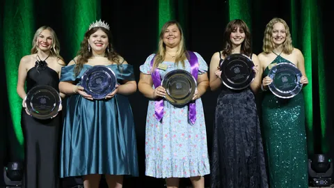 The 2025-2026 State 4-H Council officers pose with George W. Smith memorial trays, recognizing their year of service during the Clover Gala at 4-H Congress.