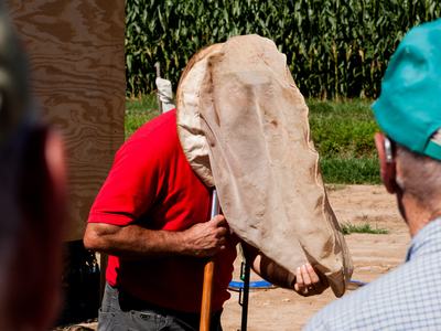 Man with insect net over head