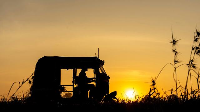 Tractor in the field at sundown