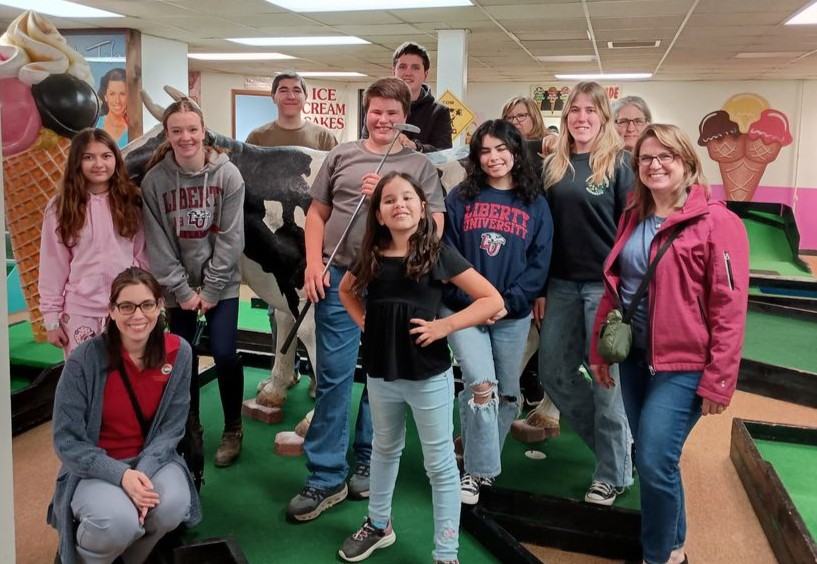 4-H Catawba County Leadership Council members taking a group picture at miniature golf, team building experience.
