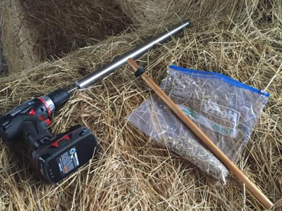 drill, hay probe, ziploc on hay