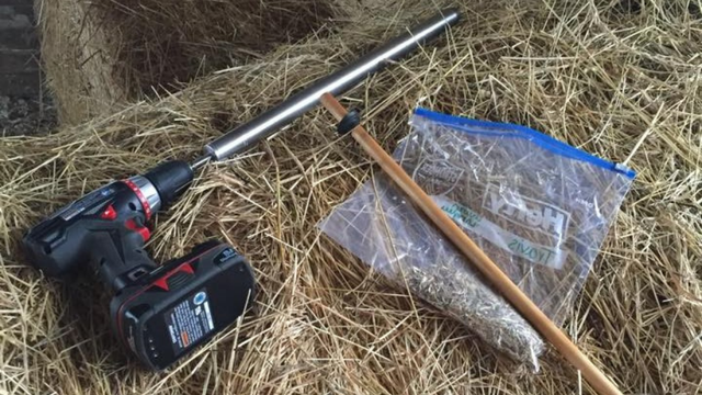 drill, hay probe, ziploc on hay