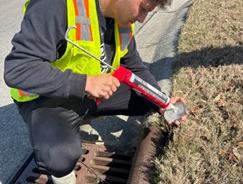 Volunteer marking storm drains during 2025 Creek Week