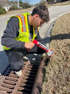 Volunteer marking storm drains during 2025 Creek Week