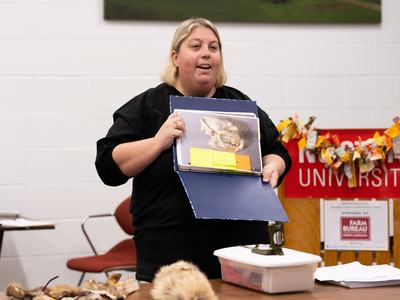Volunteer holding up an example of a presentation poster