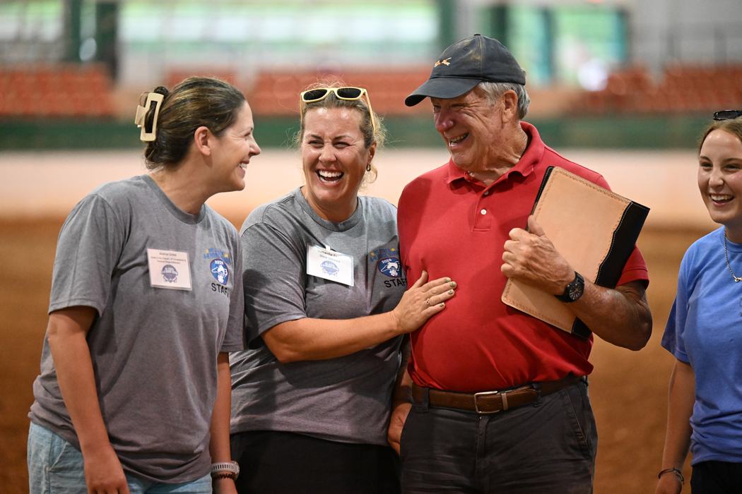 Wayne Moore poses with Alaina Cross, and Samantha and Addison Taylor as he receives his 2026 NC State 4-H Horse Show dedication Gift.