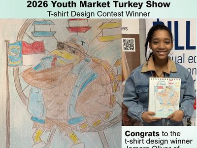 Jamara Oliver holding her drawing of a turkey with ferris wheel and state flag.