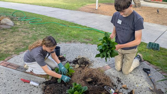 Youth planting flowers at the Arboretum.