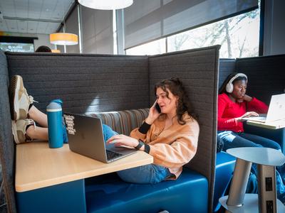 Girl with her feet kicked relaxed on her laptop