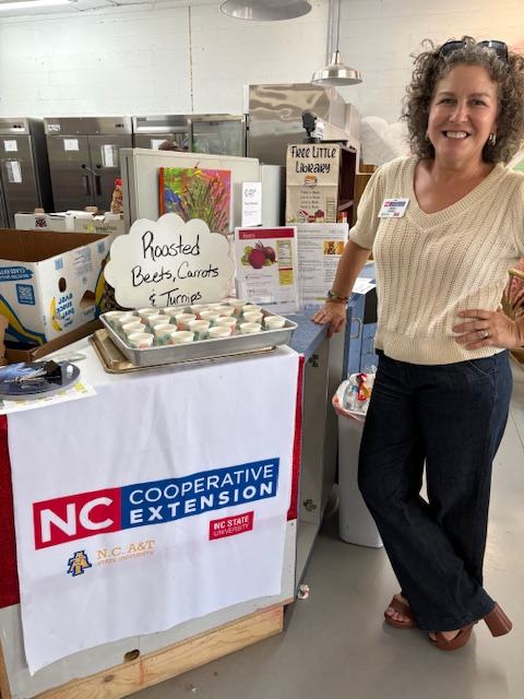Andrea Sherrill handing out taste tests made for food pantry clients using produce donations from the Donation Station