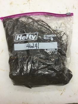 Gallon-sized zip-closure bag containing roots and soil from an aucuba shrub.