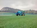 tractor spraying crops in a field