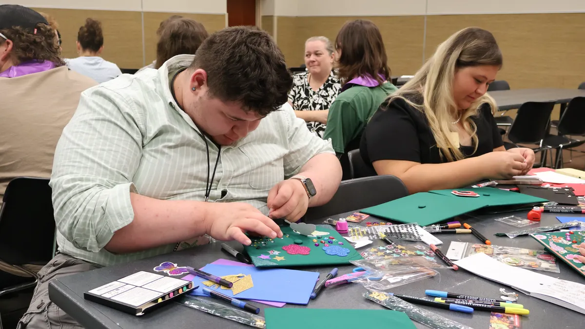 Graduating 4-H seniors decorate graduation caps at the inaugural 4-H Signing Season event held during the 2026 North Carolina 4-H Congress.