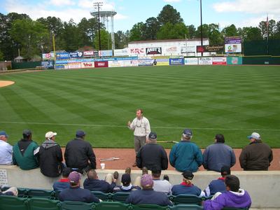 An extension speaker giving maintenance instructions at a baseball field