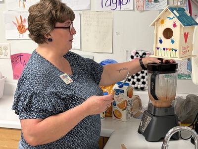 Cindy making smoothies in a blender