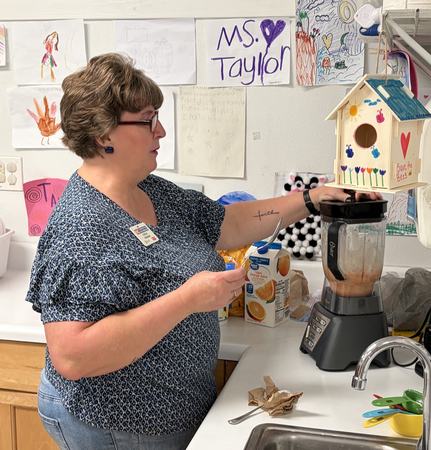 Cindy making smoothies in a blender
