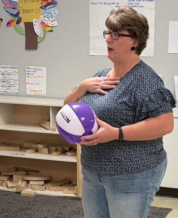 Cindy holding a play playing a game with students