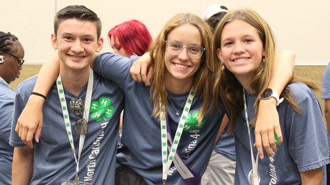 Three 4-H'ers with their arms around each other at 4-H Congress