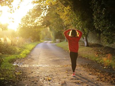 a woman walking on a trail