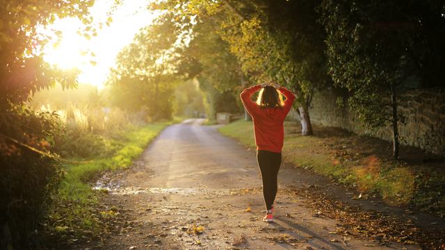 a woman walking on a trail