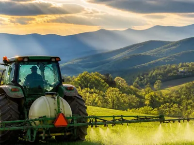 tractor spraying mountain pasture