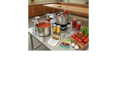 Jars of canned goods sit on a table in a large kitchen.