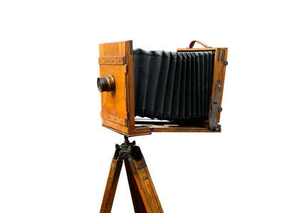 A still life of antique camera equipment, including a wooden tripod.