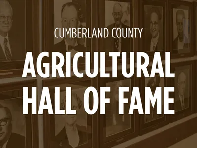 A photo of part of the Agricultural Hall of Fame portraits with the white text over brown photos.