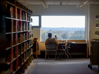 A person studies in the window of a library