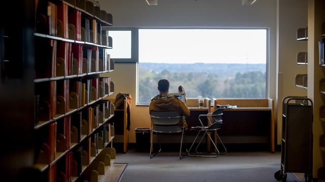 A person studies in the window of a library