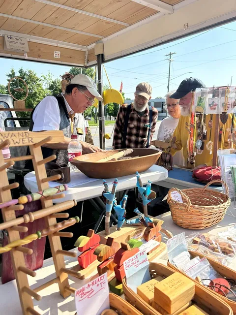 farmers market vendor selling wooden items