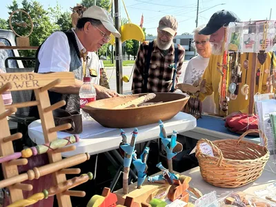 farmers market vendor selling wooden items