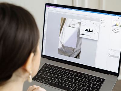 A woman edits an image using Photoshop.