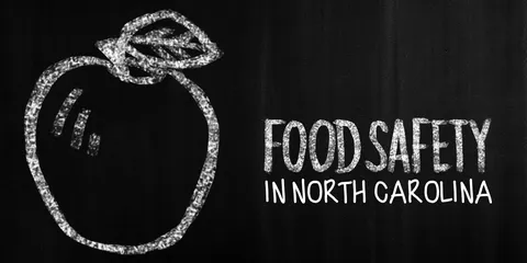 Traditional chalkboard with an apple drawn in white chalk to the left, and the words "Food Safety in North Carolina" to the right
