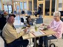 A happy couple eating at our caswell Community soup luncheon with their granddaughter.